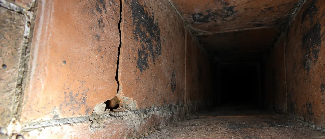 Inspection camera image of a cracked clay flue tile